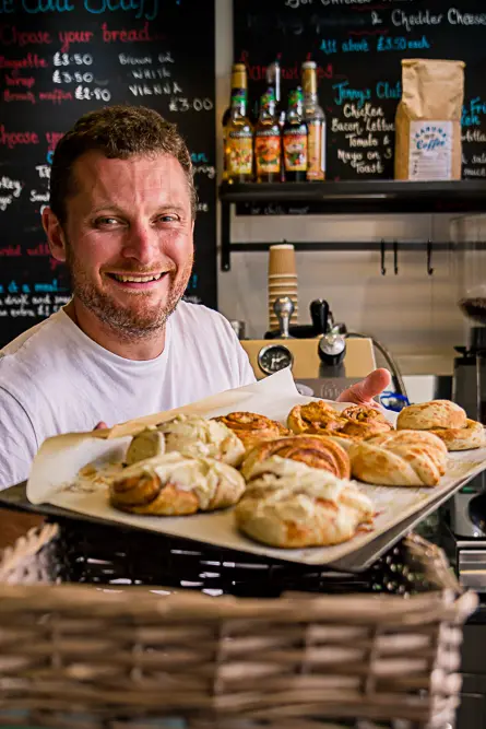 Outdoor Personal Brand Portrait of man holding tray of pasties