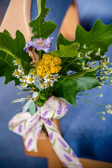 Wild flowers and large green leaves tied to a chair at Peel Street Baptist Church, Accrington