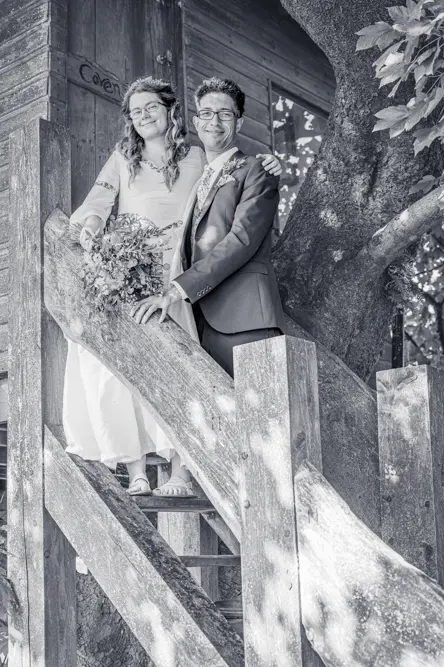 Bride and groom on the steps of the treehouse at Cronkshaw Fold Farm, Rossendale