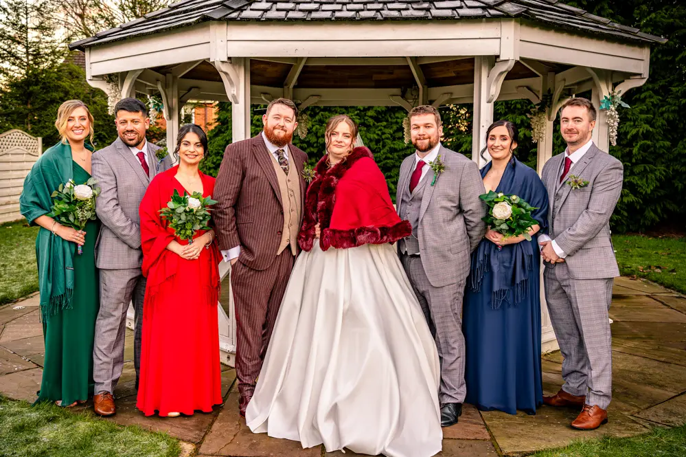 Bridal Party with bandstand behind them taken by Manchester Photographer Wedding Rebekah Morecroft