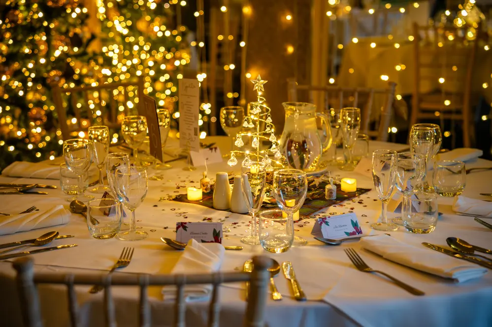 Wedding table decorations with chandelier style light up Christmas tree as centre piece