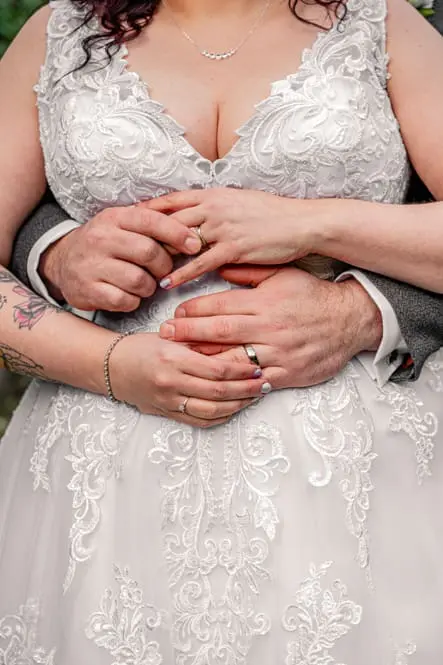 Close up of the bride and groom's hands with their wedding rings