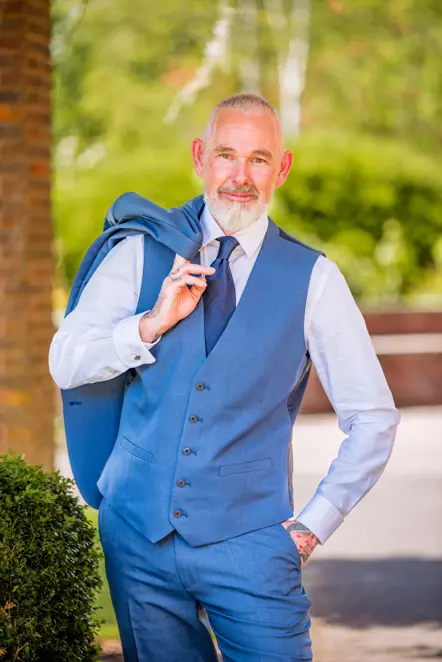 Man with suit jacket over his shoulder