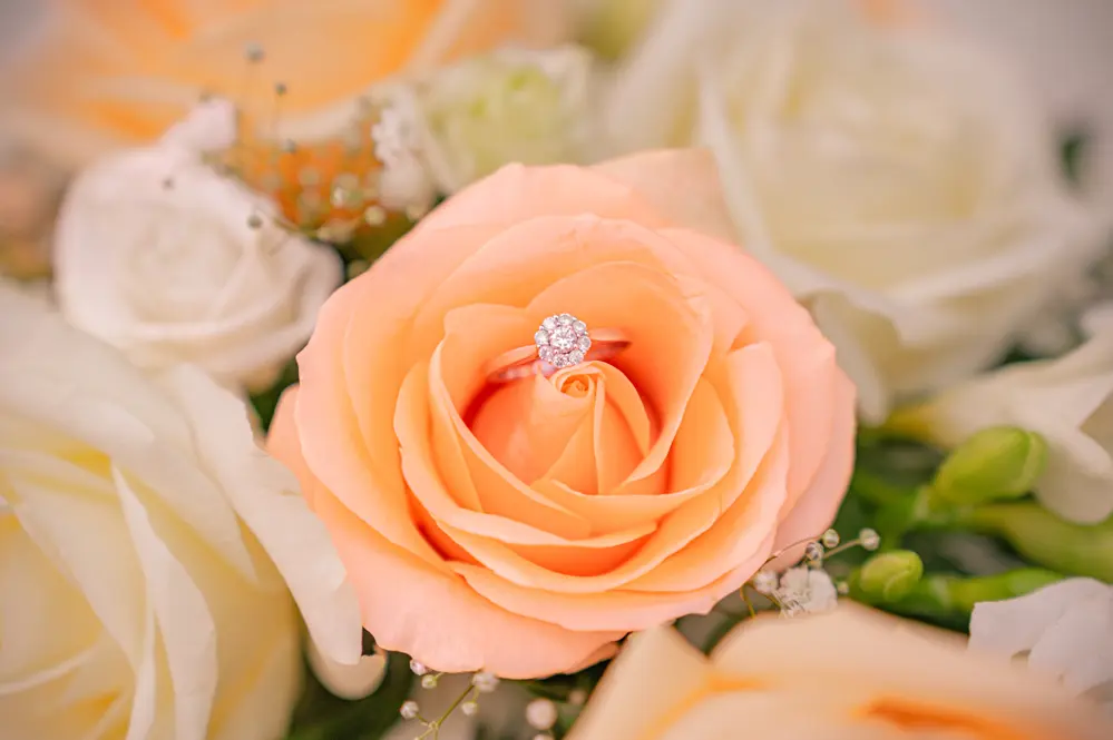 Close-up of the bride's bouquet and engagement ring before her Bury church wedding