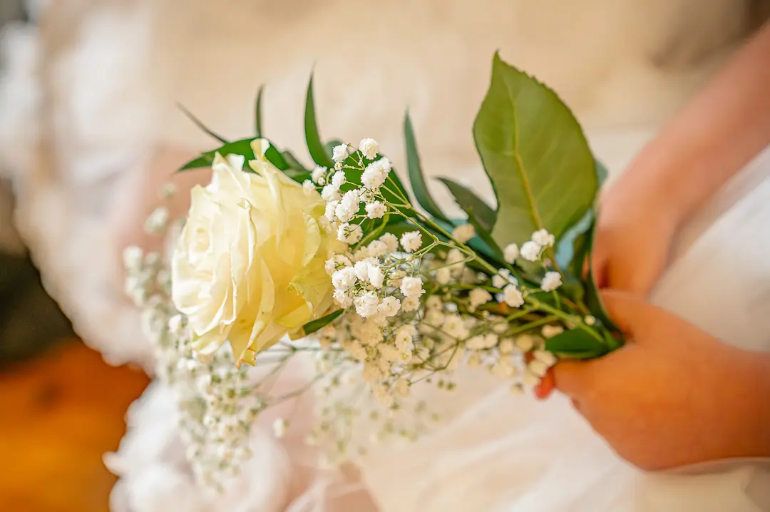 Flower girls holding white bouquets at St Peter’s Church