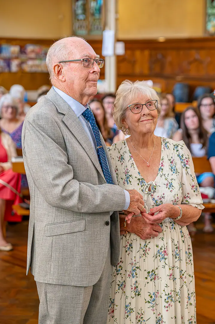 Exchanging rings during their 70th wedding celebration at St Peter’s Church, Ashton-under-Lyne, traditional Christian wedding ceremony