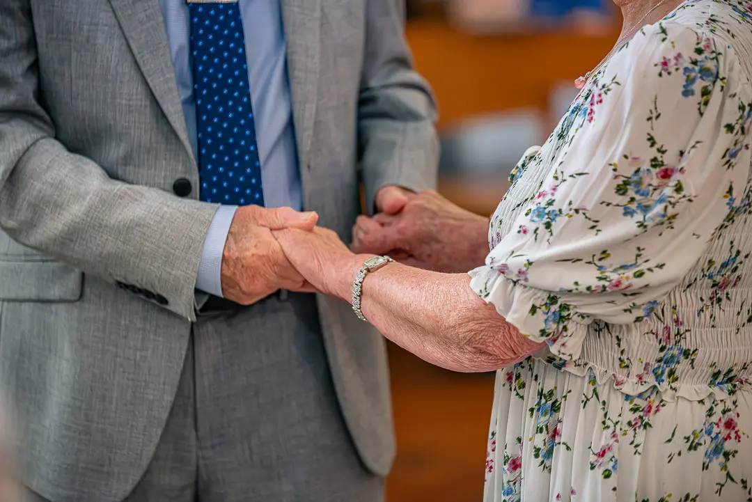 Close-up of newly exchanged wedding rings during a 70th vow renewal ceremony