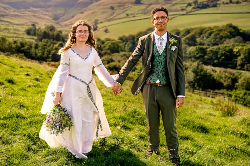 Jonathan and Miriam's Wedding at Cronkshaw Fold Farm, Rossendale Bride and groom in the rolling hills at Cronkshaw Fold Farm, Rossendale, captured by Lancashire wedding photographer Rebekah Morecroft