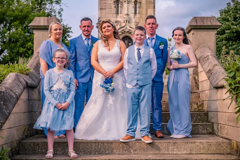 Bury Wedding Photographer, Aaron and Lauren's Wedding Party at Bury Town Hall Bride and groom Aaron and Lauren with their wedding party on the steps of Bury Winter Gardens, next to Bury Town Hall