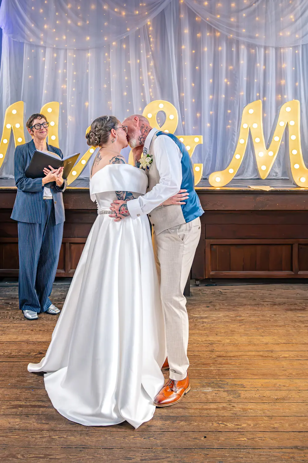 The bride and groom sharing their first kiss as a married couple