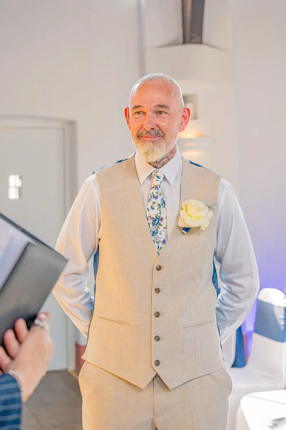 The groom waiting at the top of the aisle with a big smile