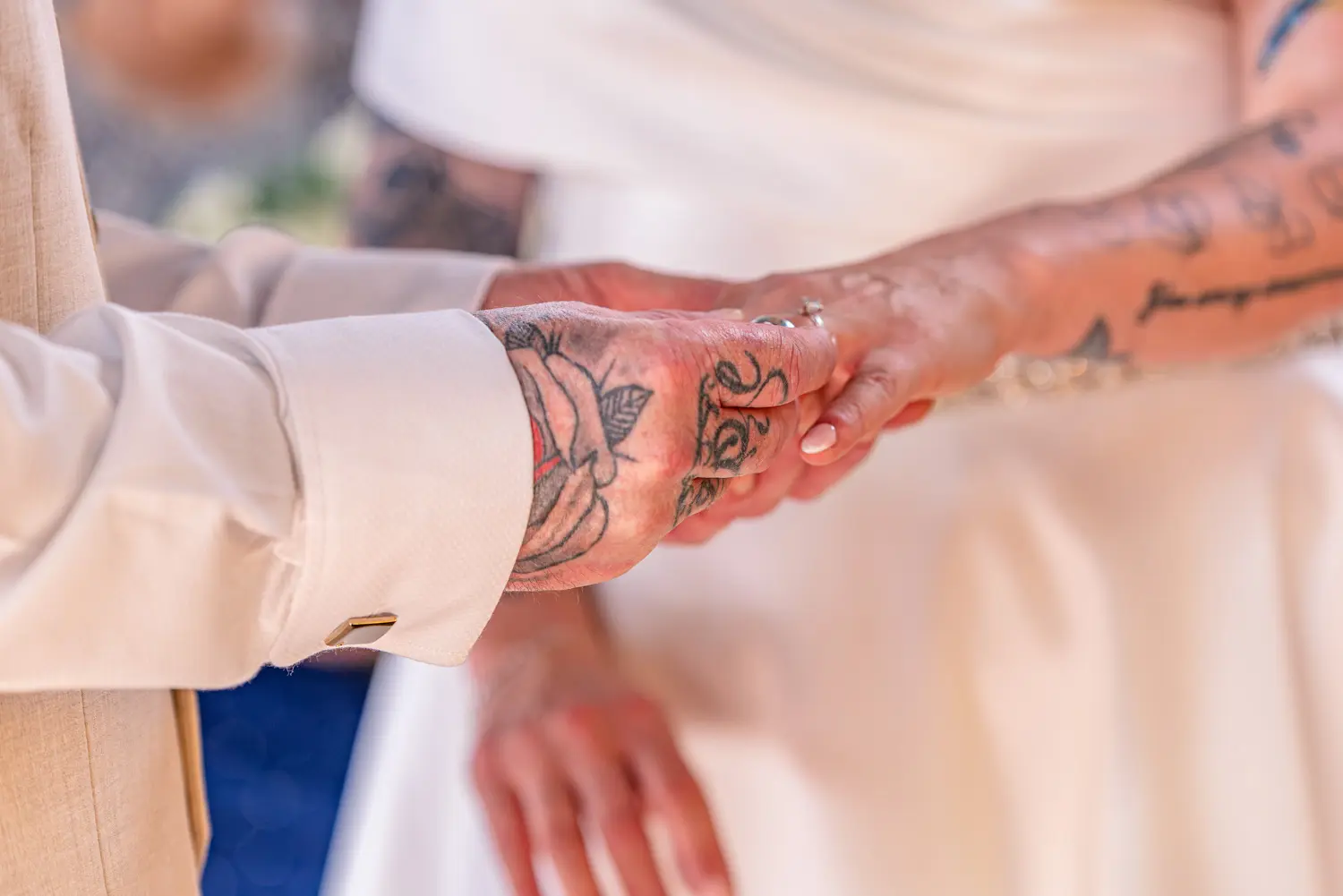 The groom placing the wedding ring on the bride's finger during the ceremony