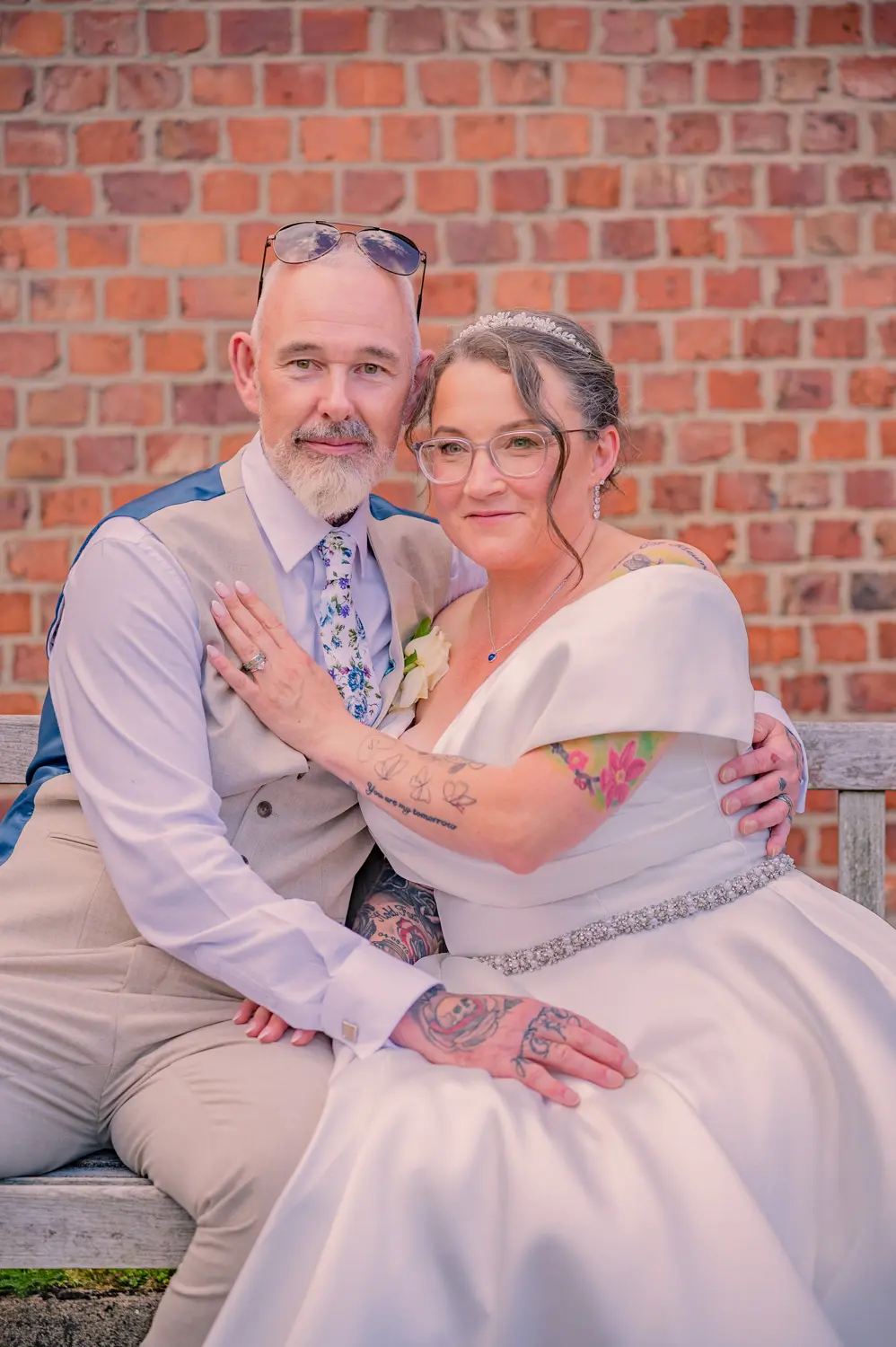 A gentle embrace between the bride and groom while seated together outside