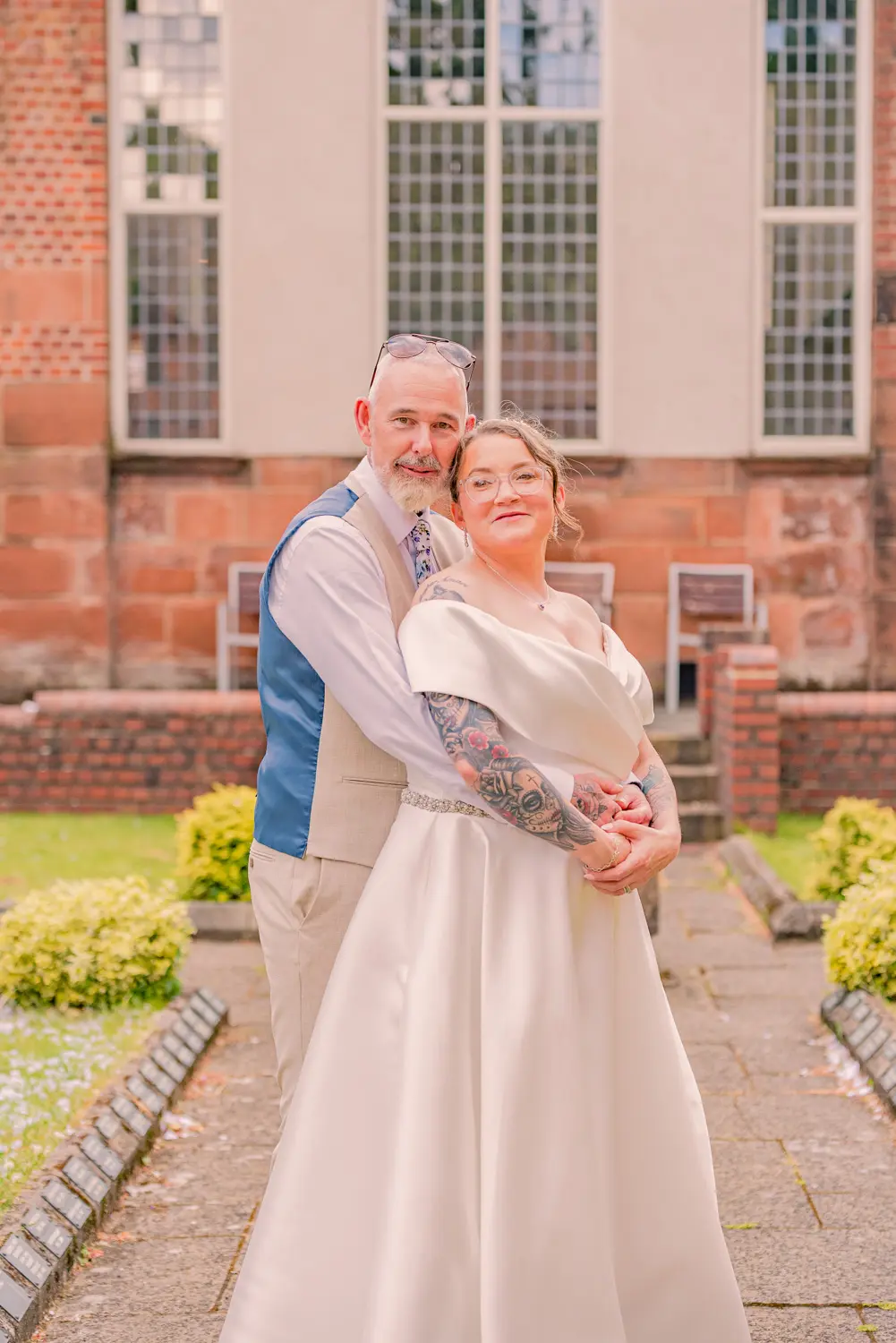 The bride and groom smiling together during their portraits outside