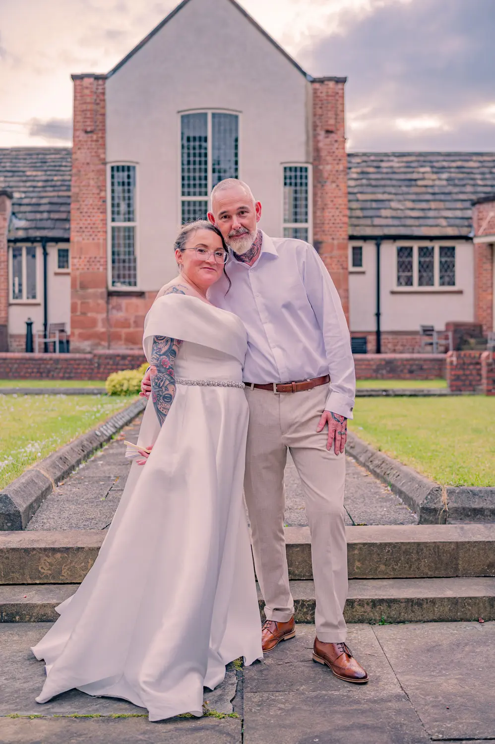 A quiet, gentle embrace between the bride and groom in the soft evening light