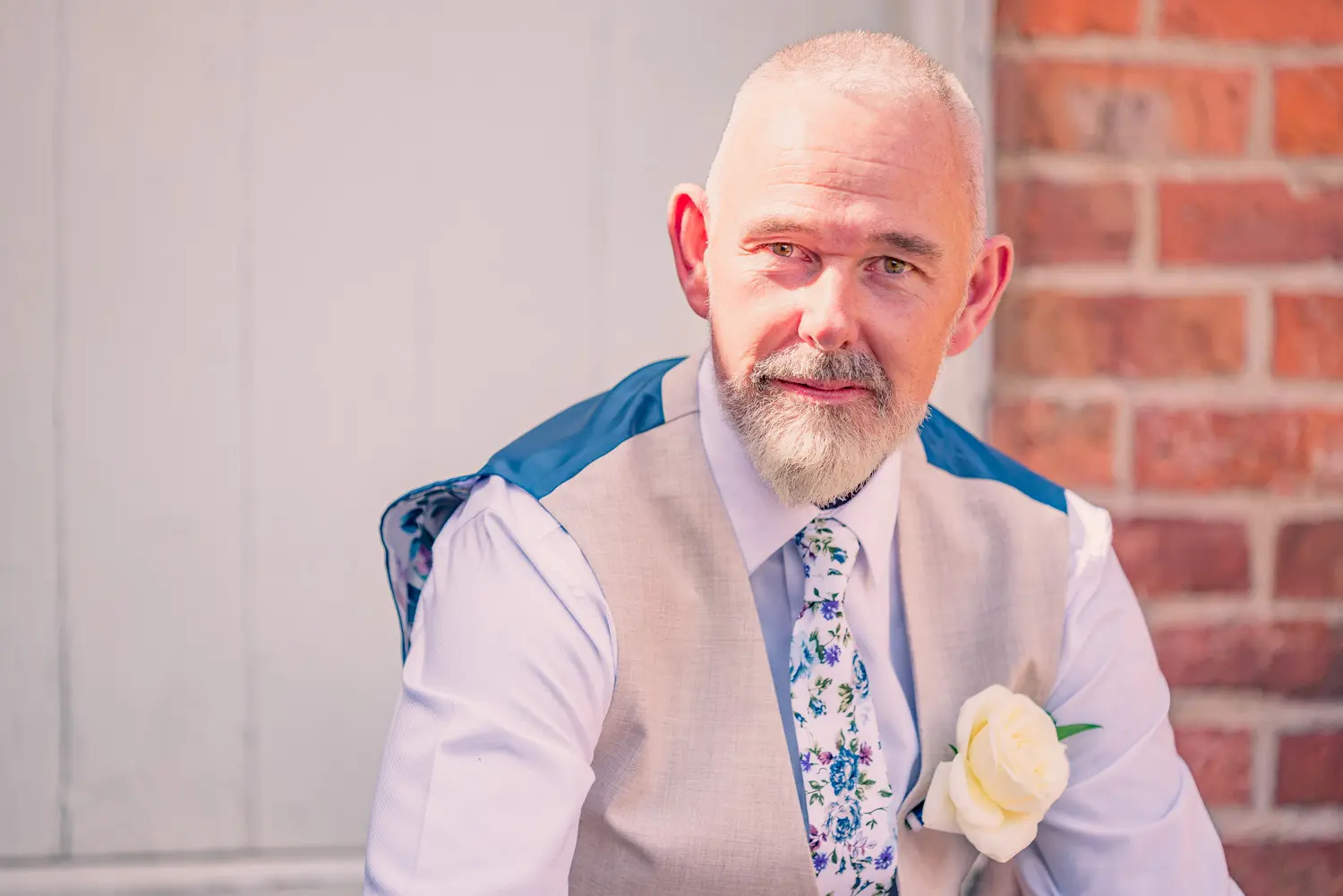Groom portrait of Paul sitting in courtyard