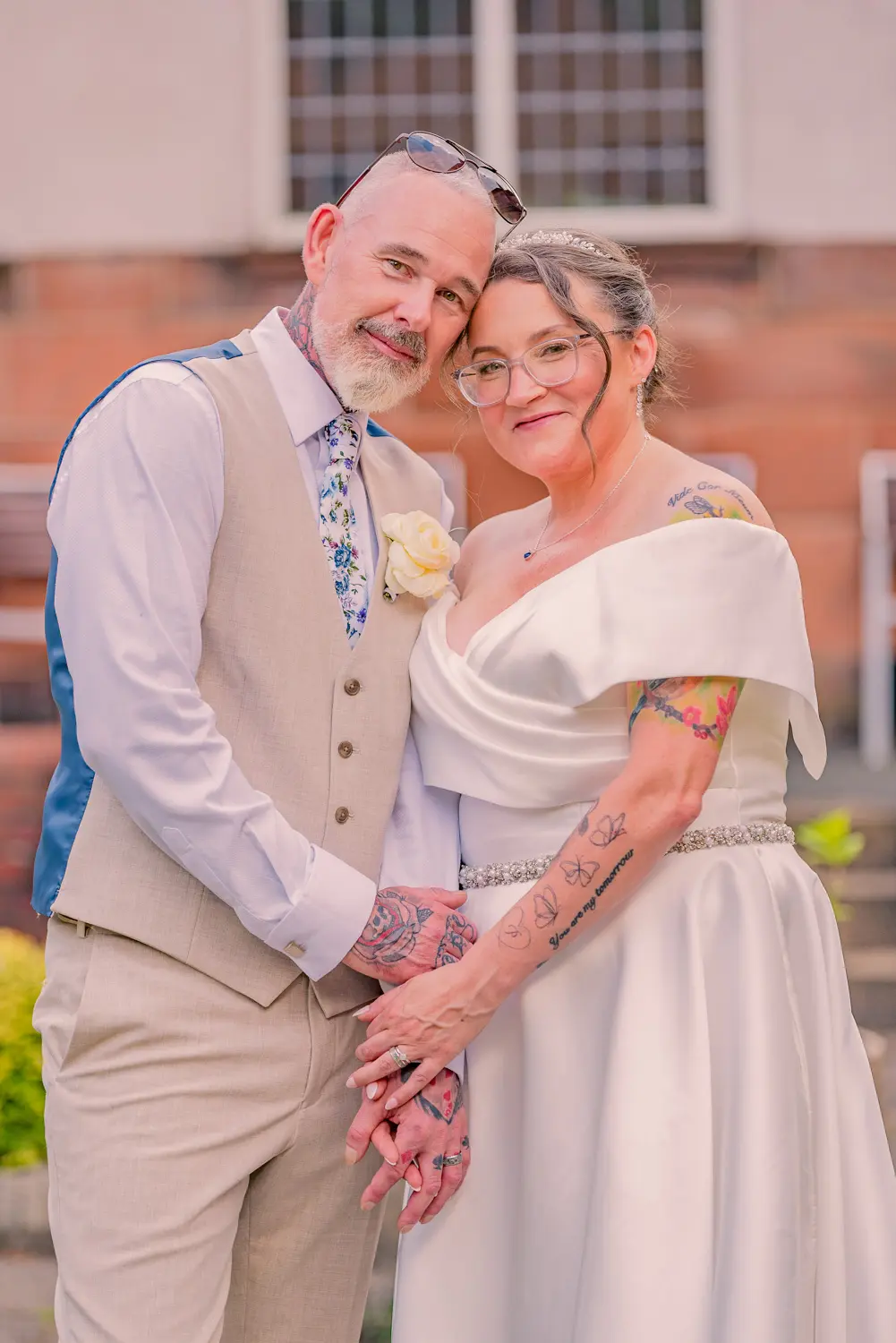 The bride and groom sharing a moment together in an open courtyard.