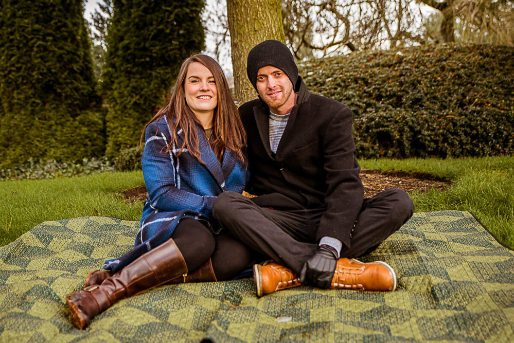 Outdoor Family Portrait of couple seating on a blanket