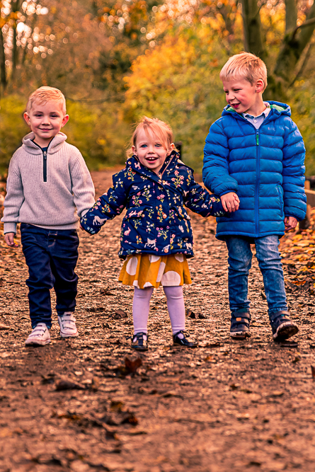 Outdoor Family Portrait of 3 young children walking.