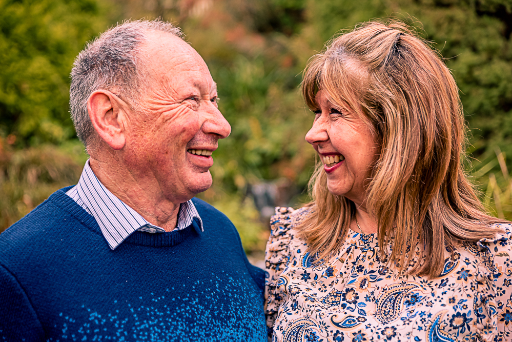 Outdoor Family Portrait of older couple looking and smiling at each other