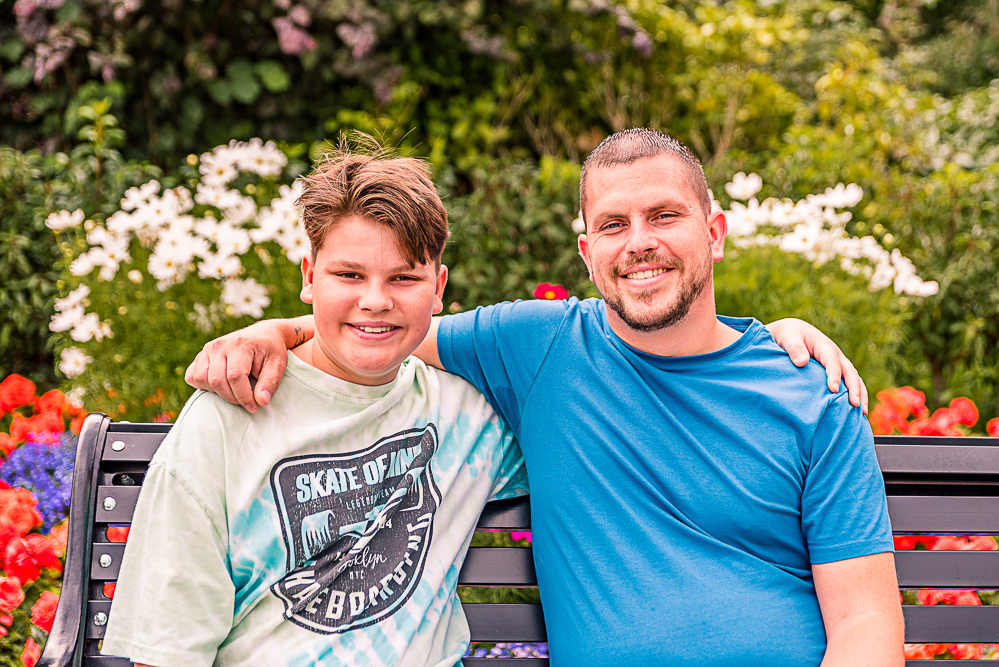 Outdoor Family Portrait of father and son with arms around each other