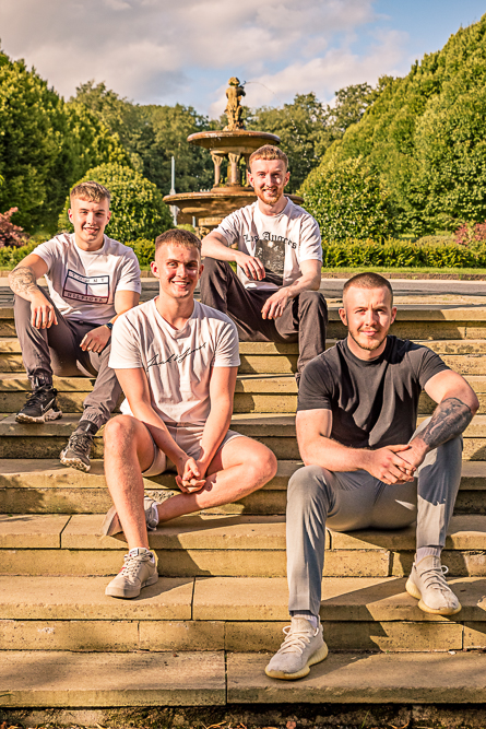 Outdoor Family Portrait of 4 young men seating on steps