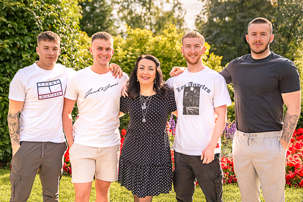 Mother with her four young adult sons, outdoor family photography