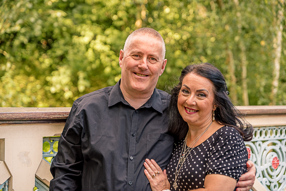 Outdoor Family Portrait of couple cuddling