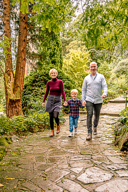 Outdoor Family Portrait of family of 3 walking holding hands