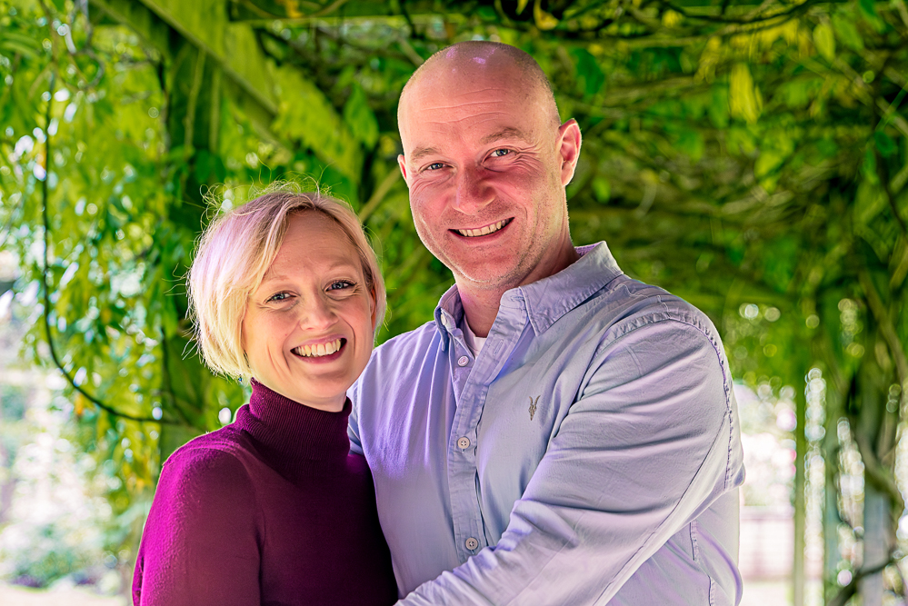 Outdoor Family Portrait of couple cuddling