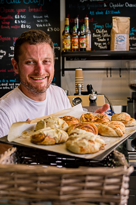 Outdoor Personal Brand Portrait of man holding tray of pasties