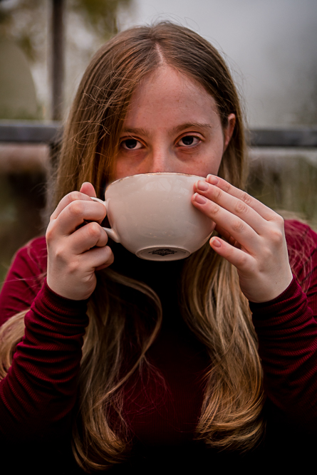 Outdoor Personal Brand Portrait of young woman drinking from a mug