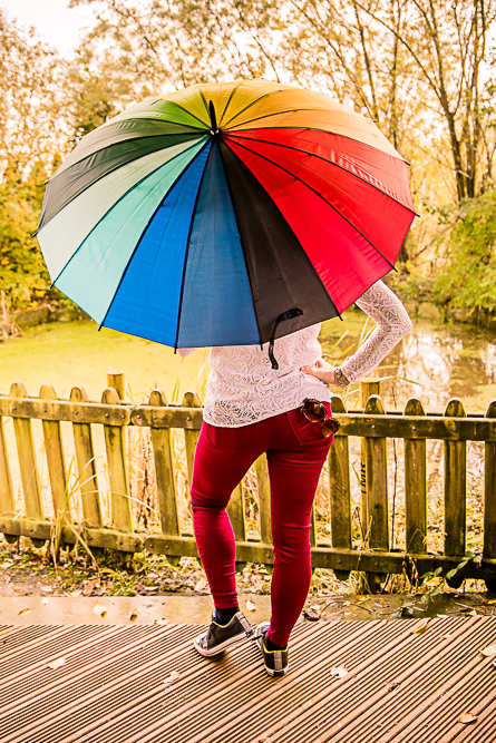 Outdoor Personal Brand Portrait of woman holding rainbow umbrella