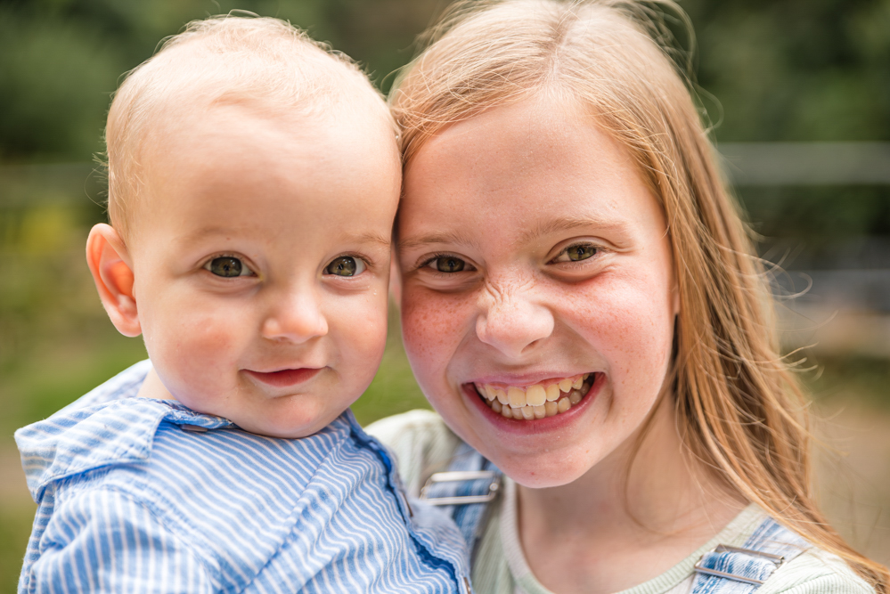 Outdoor Family Portrait of sister with baby brother