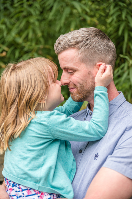 Outdoor Family Portrait of Dad and daughter toughing noses