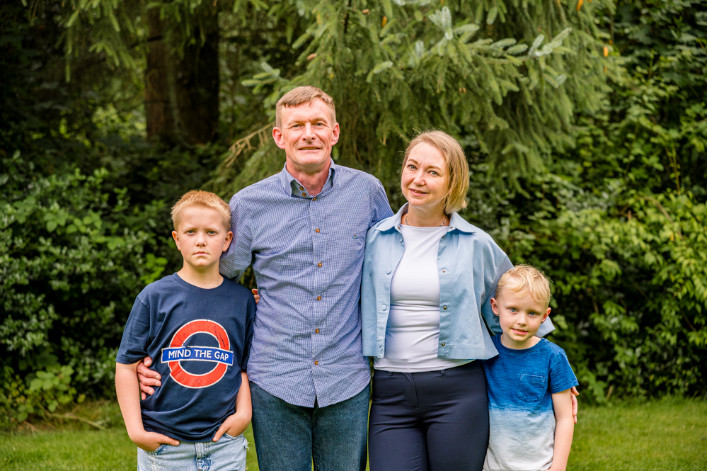 Family of four sitting outdoors, natural family photography stalybridge