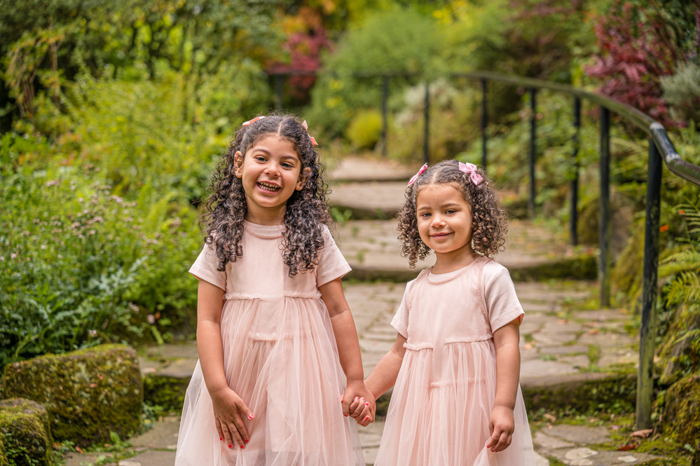 Two sisters standing outdoors, natural portrait photography