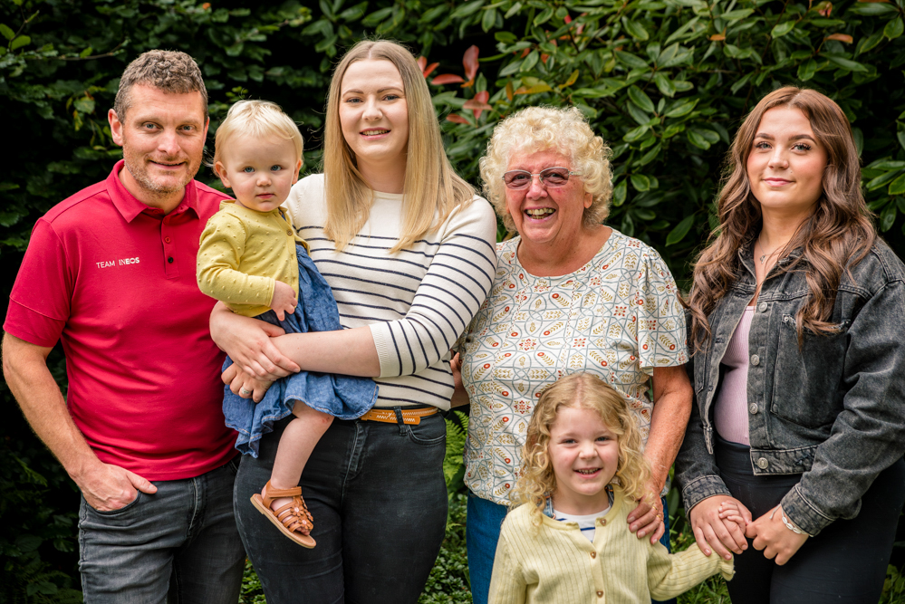 Young family of five with grandma, outdoor family portrait Dukinfield