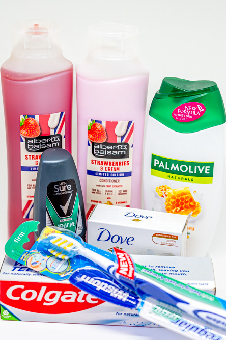 Tooth paste, tooth brush, Mens Sure roll on, Dove shea butter, shampoo, conditioner and shower gel