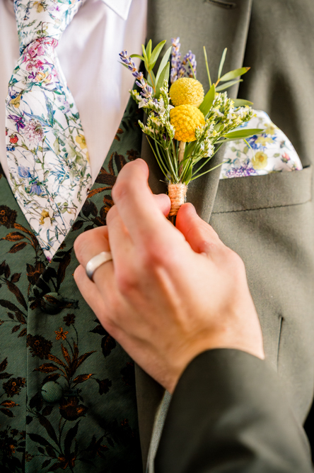 Close up of the groom having his buttonhole attached at Peel Street Baptist Church, Accrington