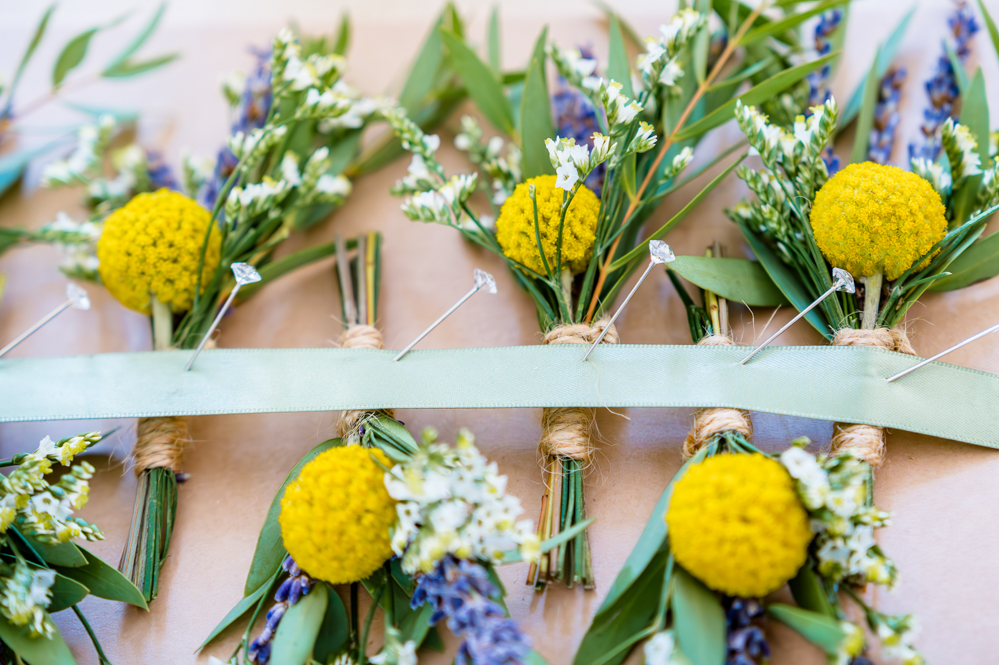 Five wild flower buttonholes laid out before the ceremony at Peel Street Baptist Church, Accrington