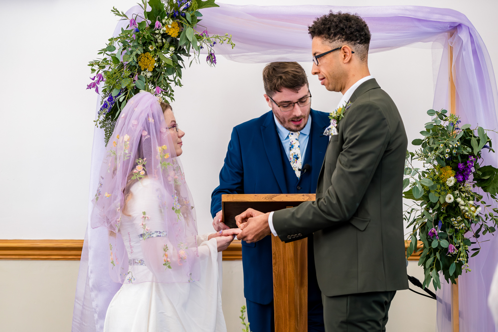 Bride and groom exchanging rings during their wedding ceremony at Peel Street Baptist Church, Accrington