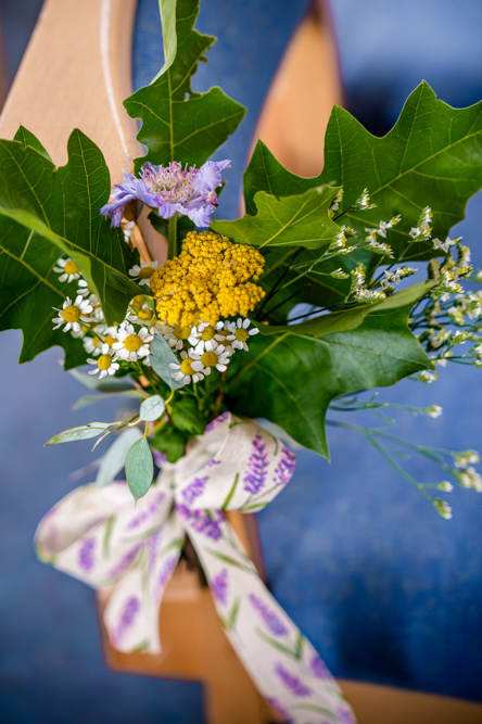 Wild flowers and large green leaves tied to a chair at Peel Street Baptist Church, Accrington