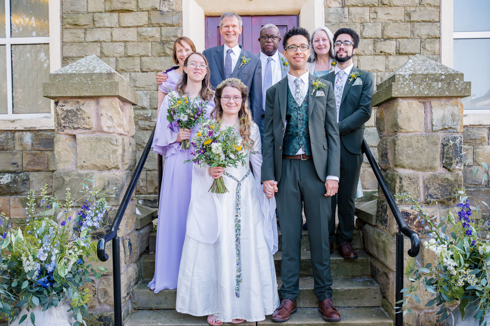 Bride and groom with both families outside Peel Street Baptist Church, Accrington