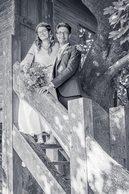 Bride and groom on the steps of the treehouse at Cronkshaw Fold Farm, Rossendale
