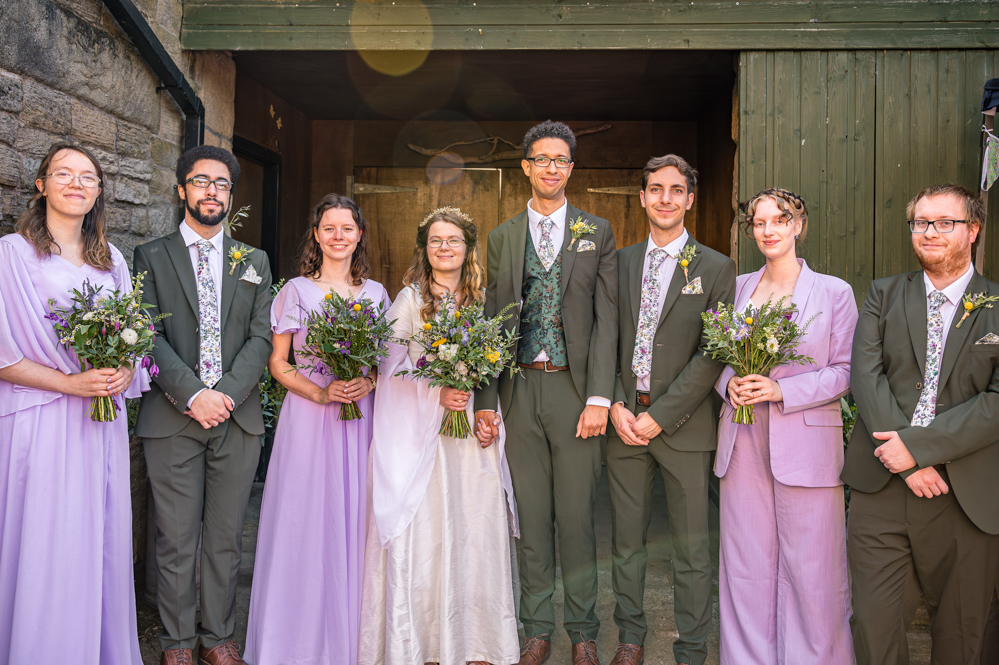 Bride, Groom and the bridal party in front of a wooden door