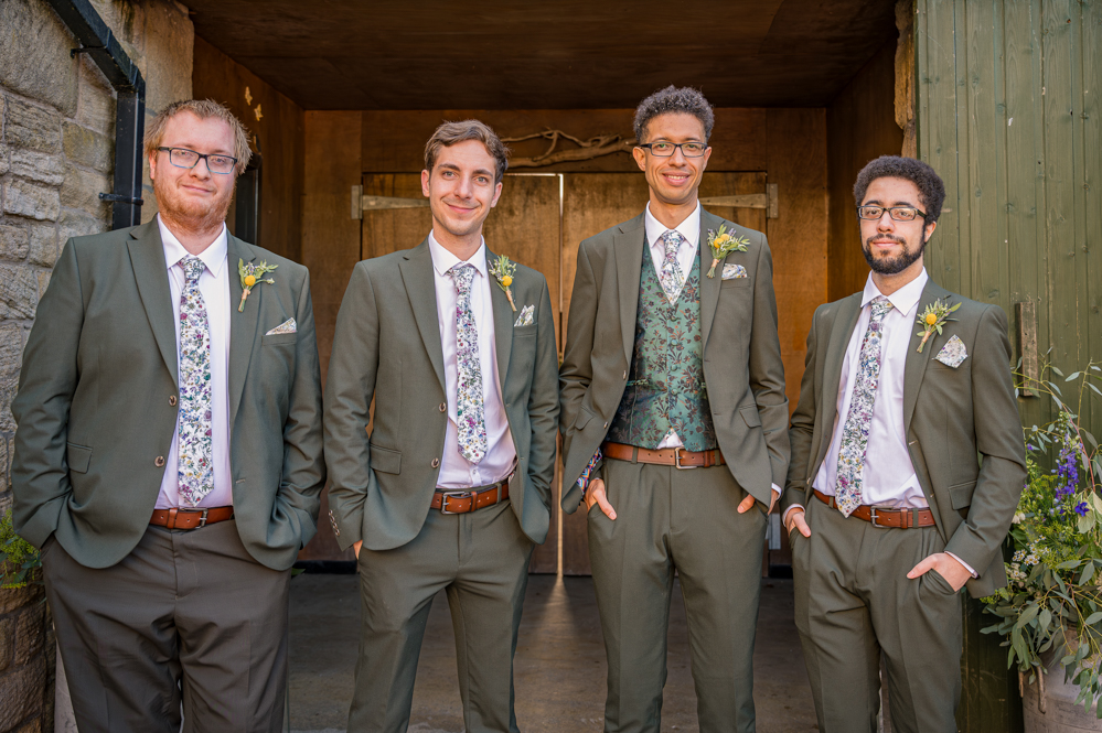 Groom and groomsmen in front of a wooden door