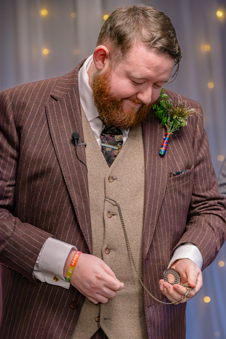Groom looking at his pocket watch.
