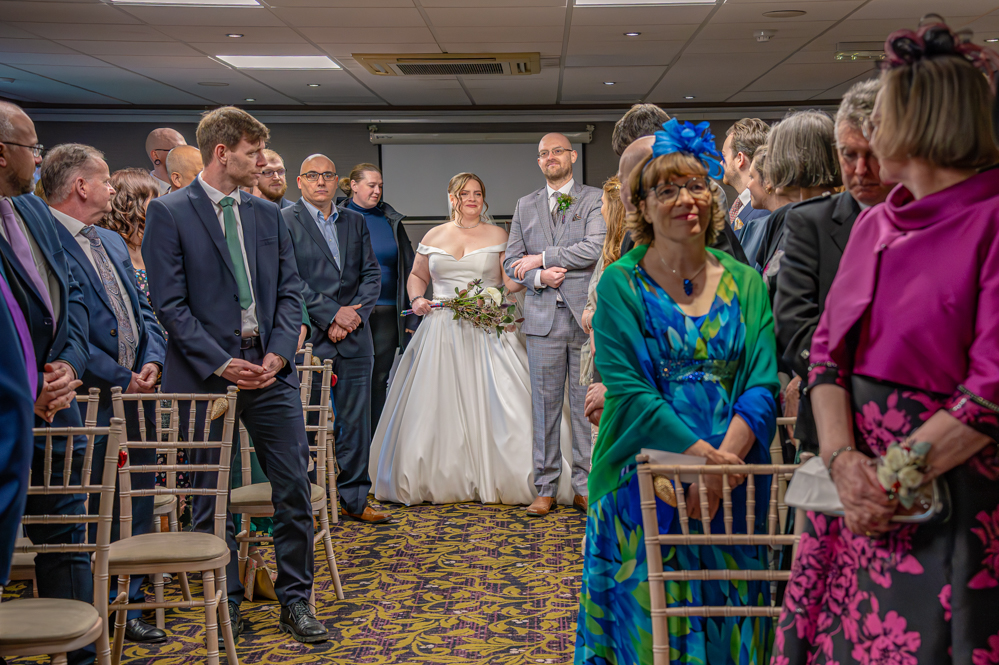 Bride and Bride's brother walk down the aisle