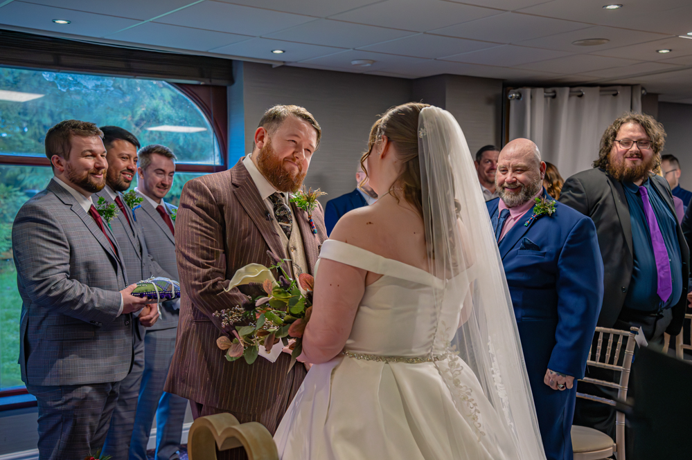 Groom smiling at bride